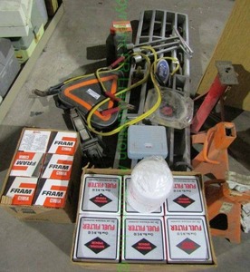 lot 88 image: Ford truck grille, Fram oil filters, jumper cables and other automotive supplies as shown