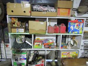 lot 109 image: Assorted home decor, toys, and more as shown, also includes shelf unit