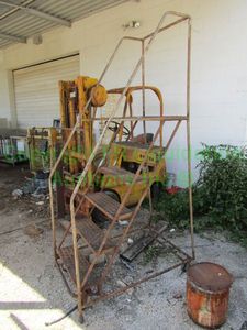 lot 411 image: Southwest materials portable stairs, missing one wheel, 87 tall