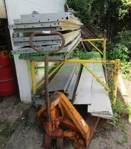 lot 415 image: Tube frame metal storage rack plus contents and pallet jack (needs repaired)