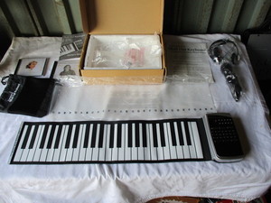 lot 112 image: Looks New-Giovannis Roll out keyboard-Piano, String Quartet, Guitar, Drum set or Saxophone