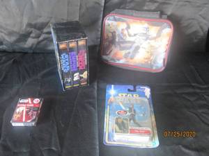 lot 324 image: 6 PC VINTAGE STAR WARS LOT&nbsp- 3&nbsp STAR WARS VHS TAPES&nbsp- STAR WARS INSULATED LUNCH BAG&nbsp- STAR WARS RESISTANCE VS FIRST ORDER PLAYING CARDS&nbsp- STAR WARS HAN SOLO ACTION FIGURE RETURN OF THE JEDI