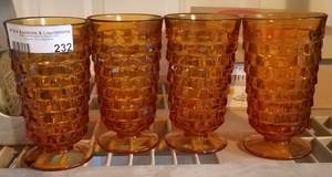 lot 232 image: LOT OF 4 AMBER GLASS FOOTED GLASSES