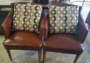 lot 516 image: 2 LEATHER STYLE ACCENT CHAIRS WITH PILLOWS (BIDDING BY THE PIECE)