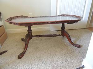 lot 7 image: Vintage Coffee Table with pierced gallery edge and glass top 38x17x20. Small piece broken on side, bottom needs repair