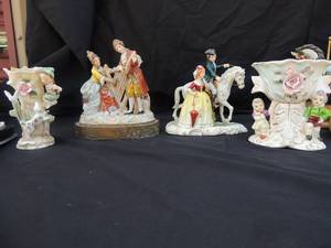 lot 56 image: Various unbranded ceramic dcor- little boy and dog, couple playing music, boy and girl next to fountain