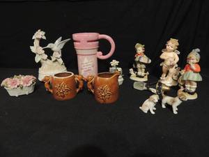 lot 98 image: Brown ceramic cream and sugar with figural handles, pink cup, children figurines, 2 mini dogs and more