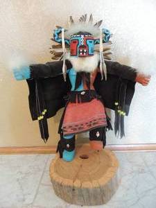 lot 93 image: Kachina  - HOTOTO DANCER  by R. Mkiana 17 x 13  on wooden stand -