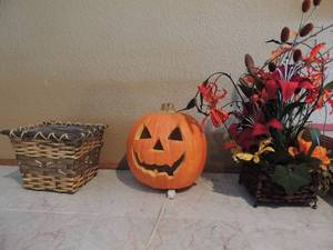 lot 84 image: Jack o lantern lighted, wicker basket used to hold candy  and Thanksgiving centerpiece