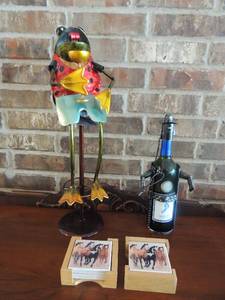 lot 12 image: 2 sets of 4 horse coasters, wine bottle tin man stands 14 tall,   metal painted frog art 23 tall