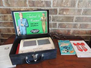 lot 101 image: 1950S DOOR TO DOOR TAILOR SALESMAN SUITCASE - custom tailoring and new notebooks