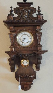 lot 144 image: VINTAGE ORNATELY CARVED GERMAN STYLE PENDULUM CLOCK   - Ye Old Clock Shop serial #A- 9578,  2 WINDING POINTS,key included 34 x 15