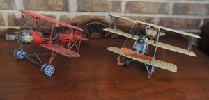 lot 57 image: Red Baron plane- metal Bi wing 12x10x7    White metal tri wing plane 14L x 11w x6 H