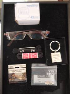 lot 103 image: Lot-Personal pedometer NIB, reading glasses, Volunteer keychain NIB, shoelaces and extra earring backs