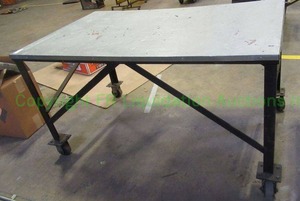 lot 142 image: Metal base and top rolling utility table. 33 x 36 x 60
