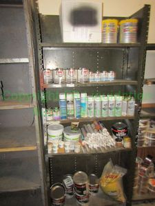 lot 217 image: Contents only of shelving unit including, Oatey PVC cement, Quick color spray paint, and more as shown