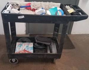 lot 47 image: Rubbermaid style utility cart on wheels with assorted contents as shown.