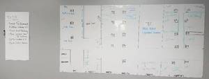 lot 49 image: Wall mounted white board style display as shown. Buyer is responsible for proper removal