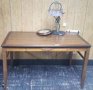 lot 55 image: Wooden table, table lamp, and wall clock in stylecolorcondition shown.