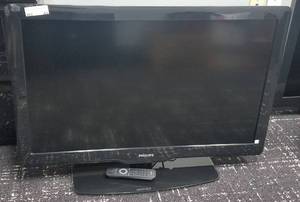 lot 63 image: Philips flat screen TV with remote in stylemodelcondition shown.