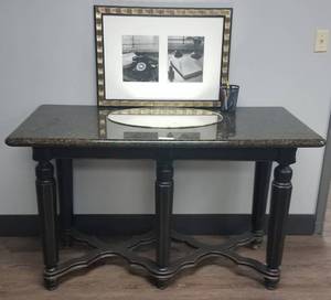 lot 69 image: Large granite top with wood base entryhallwaylobby area table in stylecolorcondition shown PLUS framed print and mirror as shown.