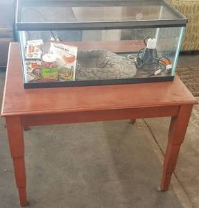 lot 88 image: Glass reptile terrarium with accessories and wooden table as shown.
