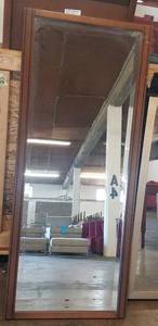 lot 338 image: Tall wood frame mirror in stylecolor shown. Condition varies. Please Note These items will be distributed on a First come - First served basis. You are bidding by the piece