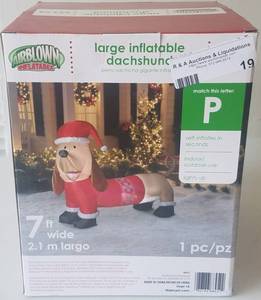 lot 19 image: Large 7 foot wide inflatable dachshund wiener dog in new, unopened box as shown.