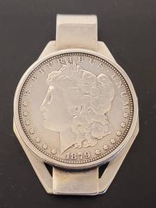 lot 178 image: ANTIQUE STERLING SILVER 1879 MORGAN SILVER DOLLAR MONEY CLIP LIBERTY #138424 AS SHOWN. WEIGHTS APPROX. 53 GRAMS AND MEASURES APPROX. 2.5 H x 1.6 W.