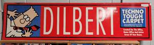 lot 14 image: DILBERT TECHNO TOUGH CARPET SIGN AS SHOWN.