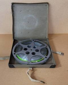 lot 40 image: VINTAGE MOVIE REEL BOX WITH FILM STRIP AS SHOWN. SEE PICTURES