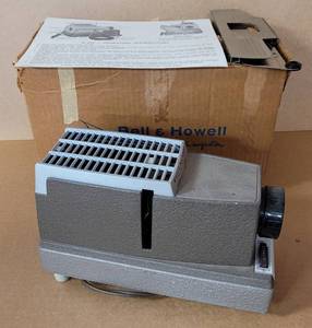lot 45 image: VINTAGE BELL & HOWELL HEADLINER MODEL 707 MOVIE FILM PROJECTOR WITH ORIGINAL BOX AND INSTRUCTIONS AS SHOWN.