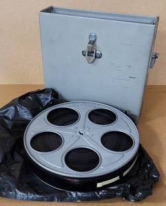 lot 47 image: VINTAGE METAL MOVIE REEL BOX WITH FILM STRIP AS SHOWN. CHECK IT OUT