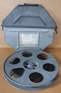 lot 52 image: VINTAGE METAL MOVIE REEL BOX WITH FILM STRIP AS SHOWN.