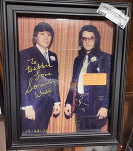 lot 88 image: FRAMED ELVIS PRESLEY AND SONNY WEST PICTURE AT SONNY WESTS WEDDING. SIGNED BY SONNY WEST 12281970.
