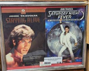 lot 114 image: FRAMED JOHN TRAVOLTA MOVIE MEMORABILIA AS SHOWN.
