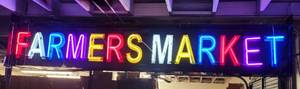 lot 167 image: HUGE FARMERS MARKET NEON SIGN IN WORKING CONDITION AS SHOWN. THIS ITEM MEASURES APPROX. 12.5 FT LONG X 30 HIGH X 8 WIDE. BUYER IS RESPONSIBLE FOR PROPER REMOVAL FROM WHERE IT IS HANGING. CHECK IT OUT