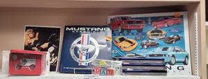 lot 282 image: LOT OF ASSORTED ITEMS INCLUDING MUSTANG CHRONICLE 35TH ANNIVERSARY, METAL WALL DECOR, TEXACO TIN WITH TRUCK AND MORE AS SHOWN.
