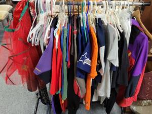 lot 306 image: CLOTHES RACK WITH CONTENTS INCLUDING T-SHIRTS, JACKETS, AND MORE IN VARIOUS SIZES, STYLES, COLORS AS SHOWN. GREAT MIXED LOT