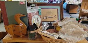 lot 315 image: EMBROIDERED TEA NAPKINS, CROCHETED STYLE DOILYS, FRAMED ART, GRILLING APRON, 1946 BOOK, AND MORE AS SHOWN.