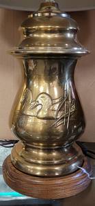lot 348 image: DUCK THEMED PRESSED BRASS LAMP WITH WOOD BASE AS SHOWN.