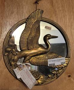 lot 357 image: ROUND SOLID BRASS MIRRORED FLYING DUCK PLAQUE IN STYLECOLORCONDITION SHOWN. 9.5 DIAMETER.