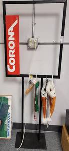 lot 438 image: COMMERCIAL METAL FRAME SIGN HOLDER, VINTAGE CORONA (ELECTRONICS) SIGN, CHRISTMAS UT HATS AND MORE AS SHOWN.