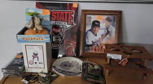 lot 442 image: SPORTS MEMORABILIA INCLUDING CAL RIPKEN FRAMED PICTURE, NC STATE CANVAS, COWBOYS PHONE CASES, PAPER PLATES AND MORE AS SHOWN. GREAT MIXED LOT