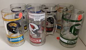 lot 447 image: BEER MUG STYLE NFL GLASSES WITH HANDLE WITH VARIOUS TEAM LOGOS AS SHOWN.