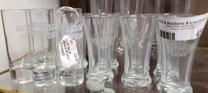 lot 453 image: LOT OF SHOT GLASSES INCLUDING HEINEKEN LIGHT AND ABSOLUTE VODKA AS SHOWN.
