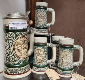 lot 454 image: VINTAGE AVON 1980S SPORTSMAN BEER STEIN AND 4 MATCHING MINI STEINSGLASSES AS SHOWN.