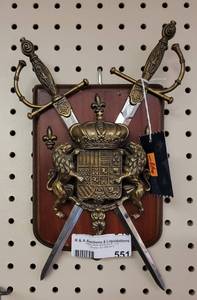 lot 551 image: WOOD AND BRASS LIONS CREST WITH SWORDS PLAQUE AS SHOWN.