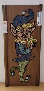 lot 554 image: VINTAGE MID-CENTURY HANDMADE GRAVEL ART-PIXIE AS SHOWN. MEASURES APPROX. 17 X 17.75.