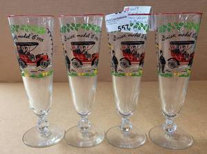 lot 557 image: VINTAGE 1950S LIBBY PILSNER GLASSES WITH BUICK MODEL C 1905 DESIGN AS SHOWN.